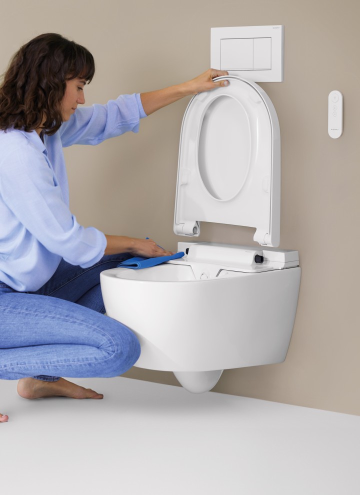 Woman cleans Geberit AquaClean Alba